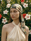 Woman wearing a sage floral headscarf with a colorful background of flowers
